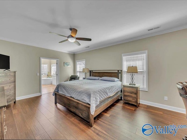 414 Wood Sage Ln, Huntsville, AL 35824 - bedroom featuring crown molding, visible vents, baseboards, and wood finished floors