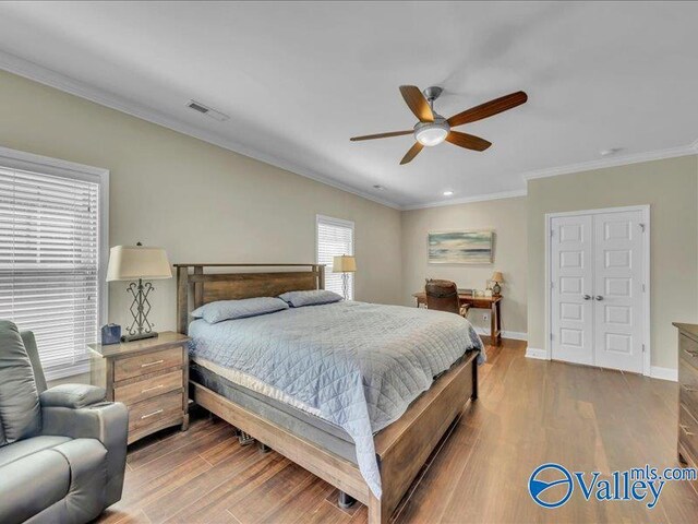 414 Wood Sage Ln, Huntsville, AL 35824 - bedroom featuring baseboards, crown molding, visible vents, ceiling fan, and wood finished floors