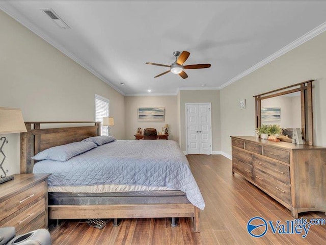 414 Wood Sage Ln, Huntsville, AL 35824 - bedroom with ornamental molding, visible vents, baseboards, and wood finished floors