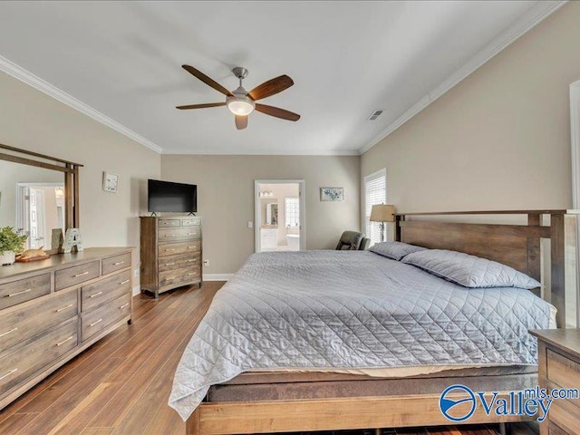 414 Wood Sage Ln, Huntsville, AL 35824 - bedroom featuring crown molding, connected bathroom, visible vents, wood finished floors, and baseboards