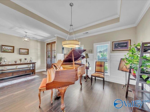 414 Wood Sage Ln, Huntsville, AL 35824 - dining space featuring crown molding, a tray ceiling, visible vents, a wainscoted wall, and wood finished floors