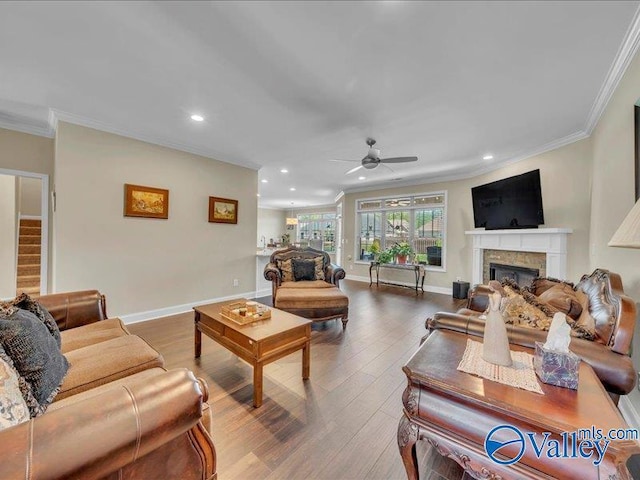 414 Wood Sage Ln, Huntsville, AL 35824 - living room featuring crown molding, wood finished floors, a fireplace, and a ceiling fan