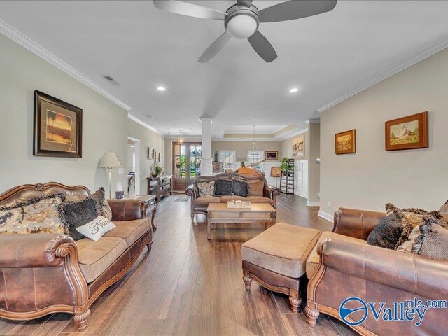 414 Wood Sage Ln, Huntsville, AL 35824 - living area featuring crown molding, wood finished floors, a ceiling fan, and visible vents