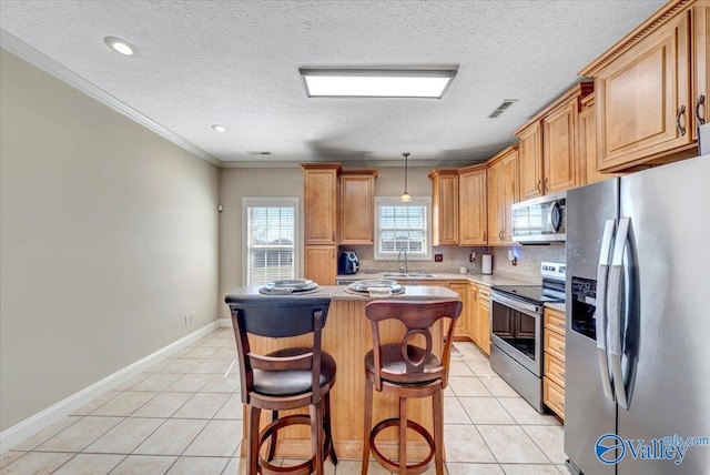 kitchen with visible vents, stainless steel appliances, backsplash, and light tile patterned flooring