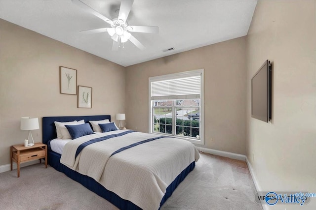 bedroom with visible vents, baseboards, a ceiling fan, and light carpet
