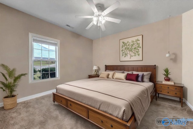 bedroom with visible vents, ceiling fan, light colored carpet, and baseboards