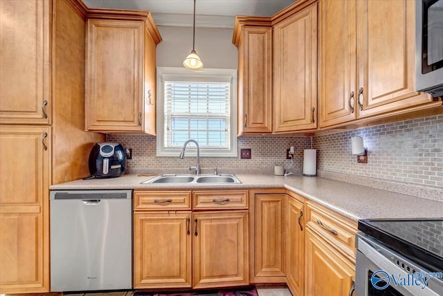 kitchen featuring stainless steel appliances, backsplash, light countertops, and a sink