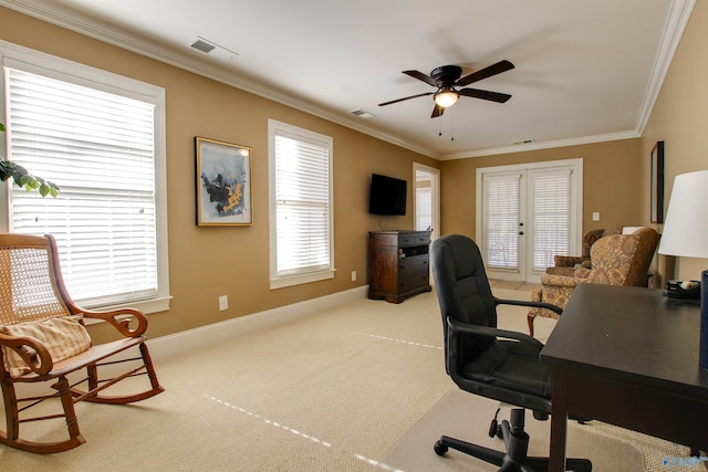 office featuring a healthy amount of sunlight, crown molding, and light colored carpet