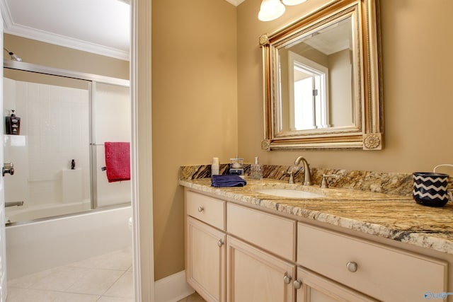 bathroom with combined bath / shower with glass door, vanity, tile patterned flooring, and ornamental molding