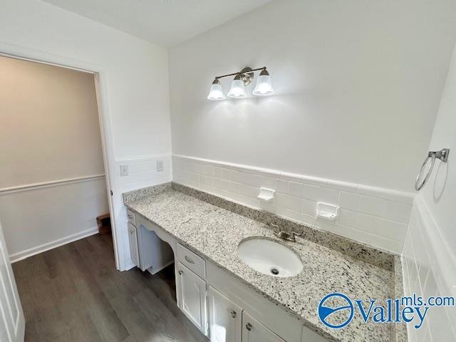 bathroom with vanity, wood-type flooring, and tasteful backsplash