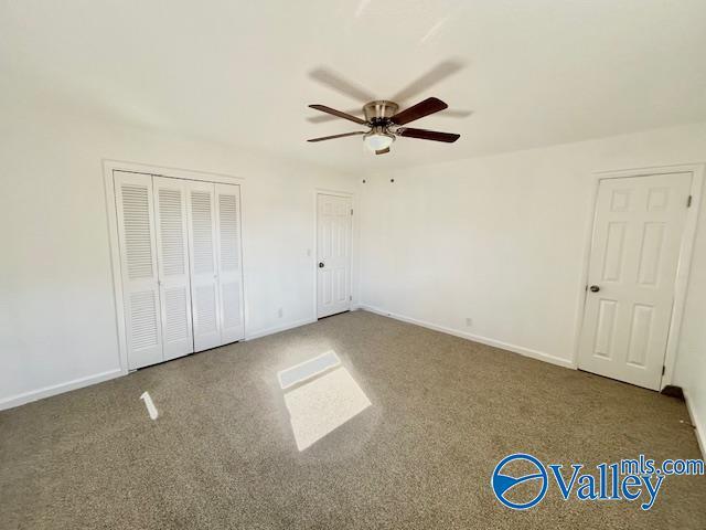 unfurnished bedroom with carpet and ceiling fan