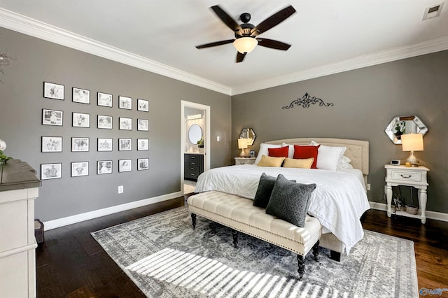 bedroom with ceiling fan, dark wood-type flooring, crown molding, and ensuite bath