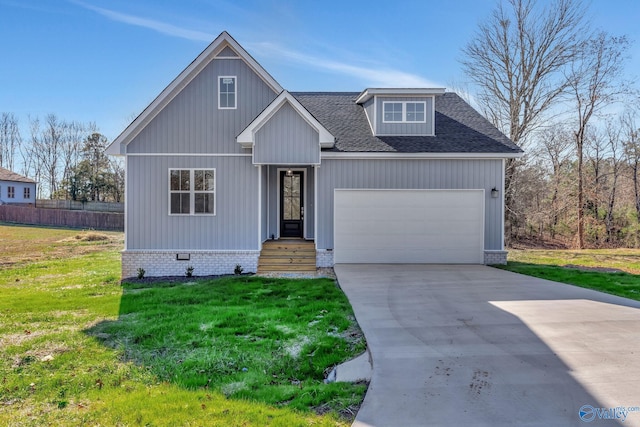 view of front facade with a garage and a front lawn