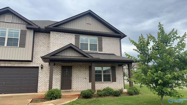 101 Huffman St, Hazel Green, AL 35750 - view of front facade featuring a garage, a front lawn, brick siding, driveway, and roof with shingles
