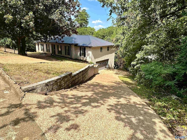 single story home featuring a front yard and a garage