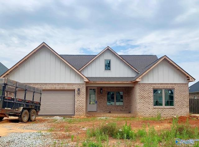 3017 Lisa Ln SE, Decatur, AL 35603 - view of front of house with brick siding, board and batten siding, roof with shingles, an attached garage, and driveway