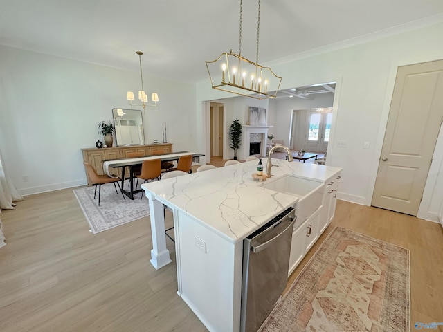 kitchen featuring an island with sink, light hardwood / wood-style floors, white cabinetry, and dishwasher