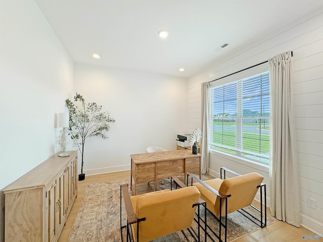 home office with light hardwood / wood-style floors