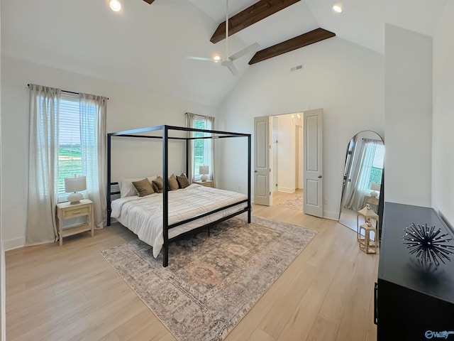 bedroom featuring light wood-type flooring, beam ceiling, and high vaulted ceiling