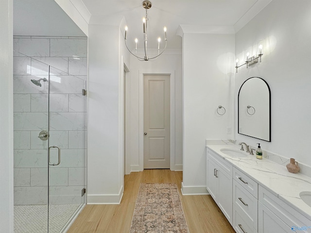 bathroom featuring vanity, hardwood / wood-style flooring, crown molding, and walk in shower