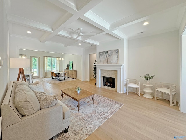 living room featuring coffered ceiling, beamed ceiling, ceiling fan with notable chandelier, and light hardwood / wood-style floors