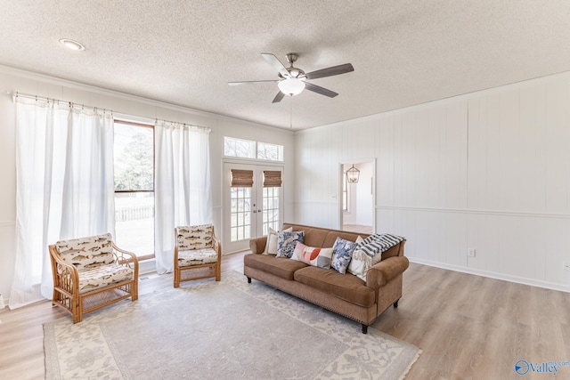 living room featuring light hardwood / wood-style floors, plenty of natural light, and a textured ceiling