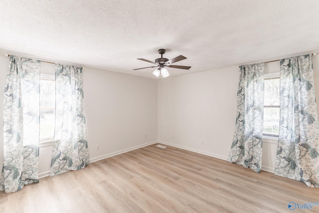 unfurnished room with light wood-type flooring, a textured ceiling, and ceiling fan