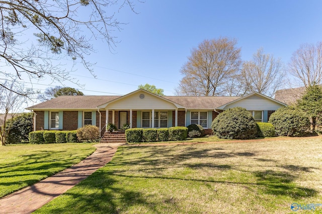 single story home with a porch and a front yard