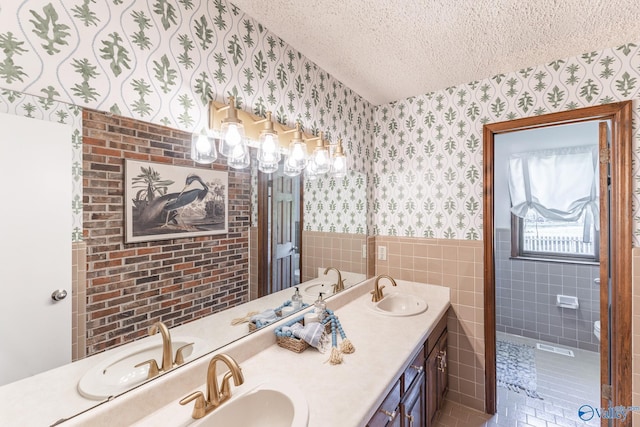 bathroom with a textured ceiling and vanity