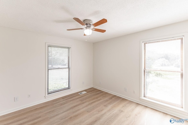 unfurnished room with light wood-type flooring, a textured ceiling, and ceiling fan