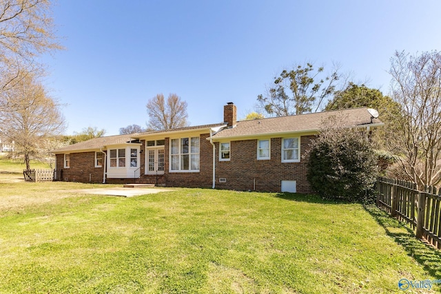 back of house featuring a patio area and a yard