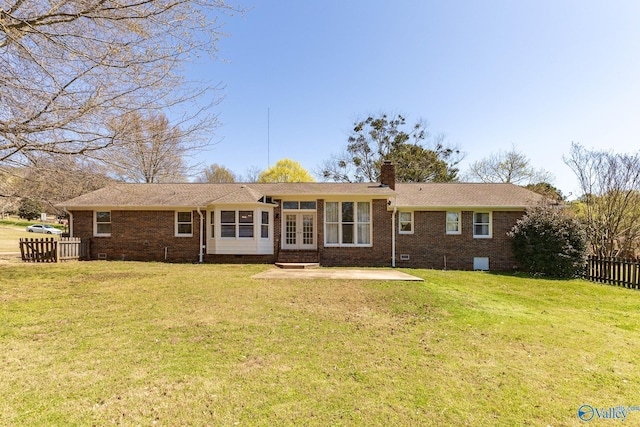 back of house with a patio area and a lawn