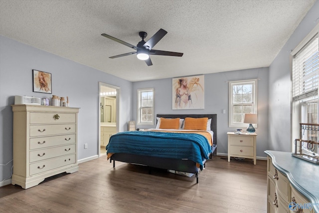 bedroom with ceiling fan, ensuite bathroom, a textured ceiling, and dark hardwood / wood-style flooring