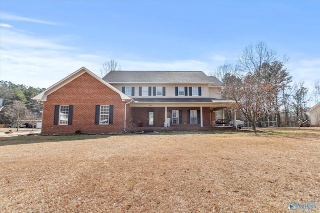 view of front of house featuring covered porch and a front yard