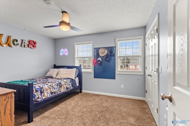 bedroom featuring ceiling fan, carpet floors, a textured ceiling, and a closet