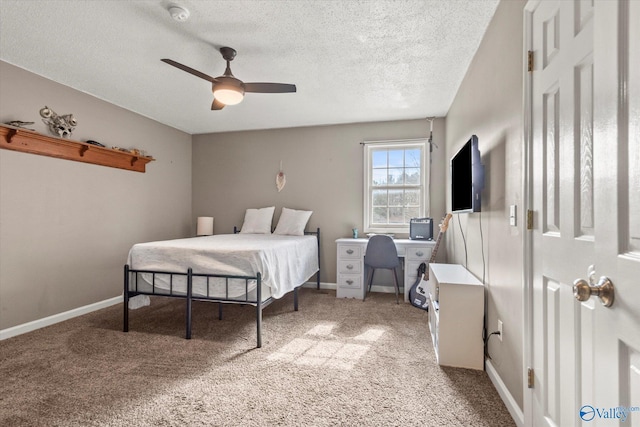 bedroom featuring ceiling fan, light carpet, and a textured ceiling