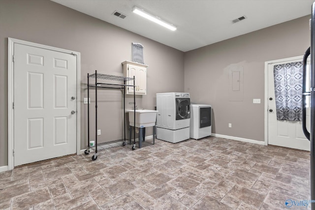 laundry room featuring cabinets and washer and dryer