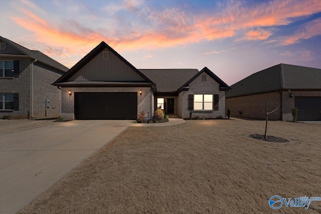 view of front of home with brick siding, driveway, and an attached garage