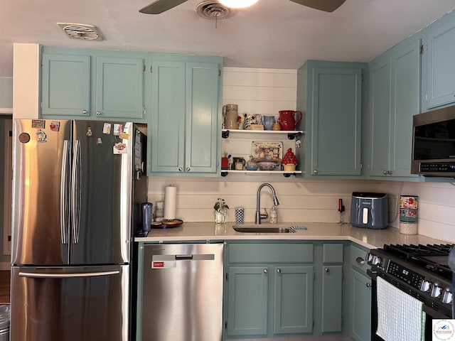 kitchen with visible vents, appliances with stainless steel finishes, light countertops, and a sink