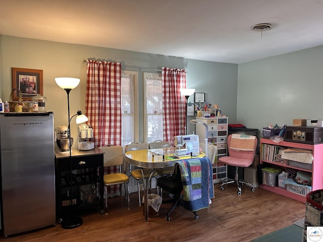 home office with visible vents and wood finished floors