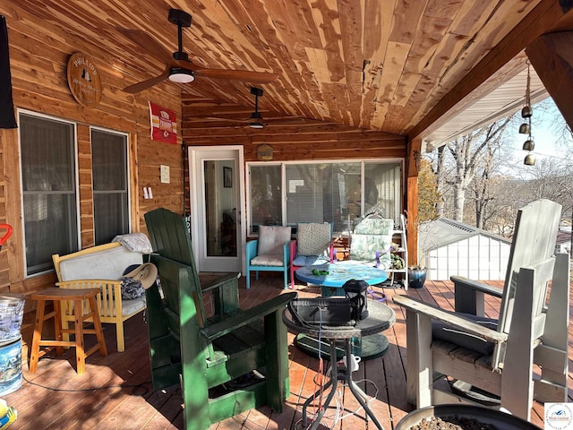 wooden deck with a ceiling fan