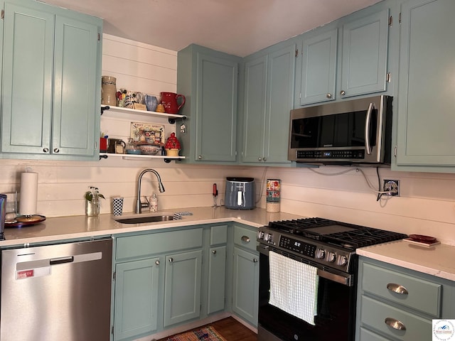 kitchen with open shelves, a sink, light countertops, appliances with stainless steel finishes, and backsplash