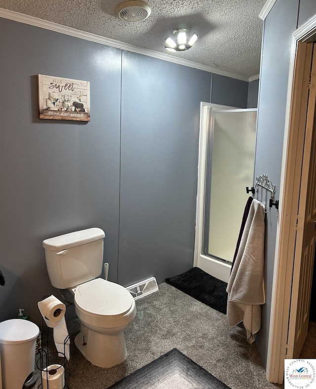 full bathroom featuring a stall shower, a textured ceiling, visible vents, and crown molding