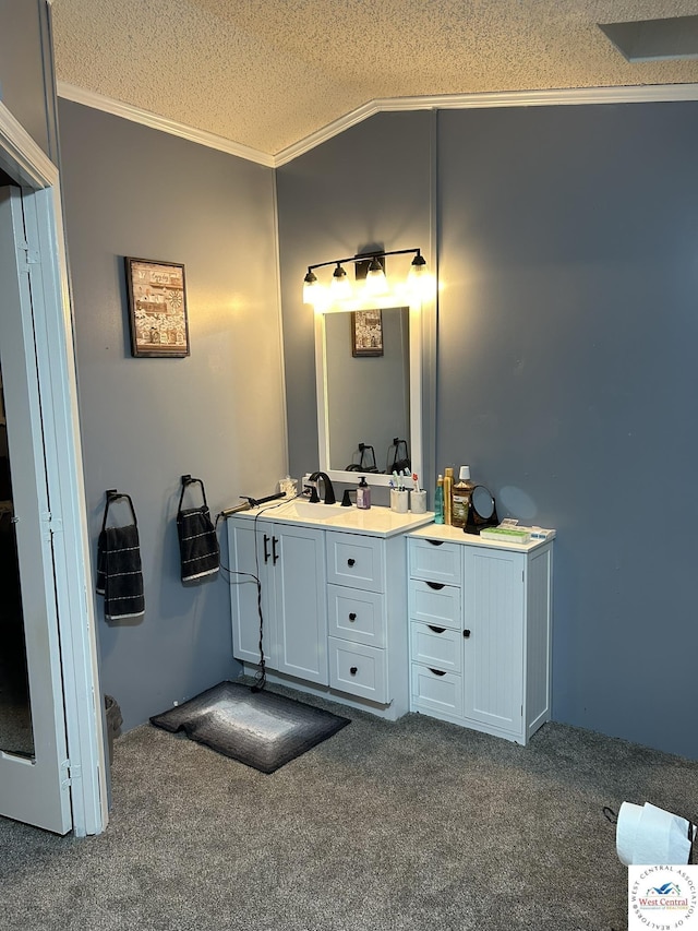 bathroom featuring lofted ceiling, crown molding, a textured ceiling, and double vanity