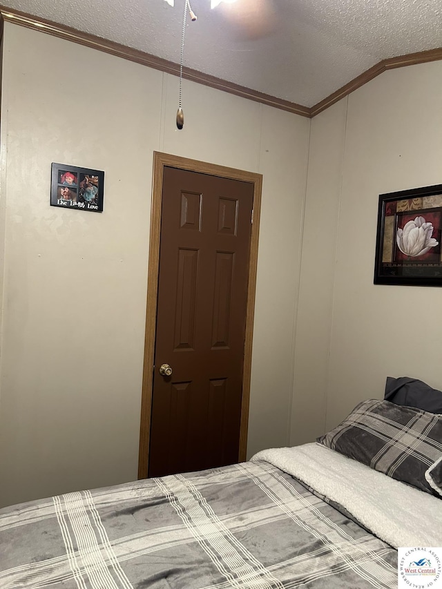 bedroom with crown molding and a textured ceiling