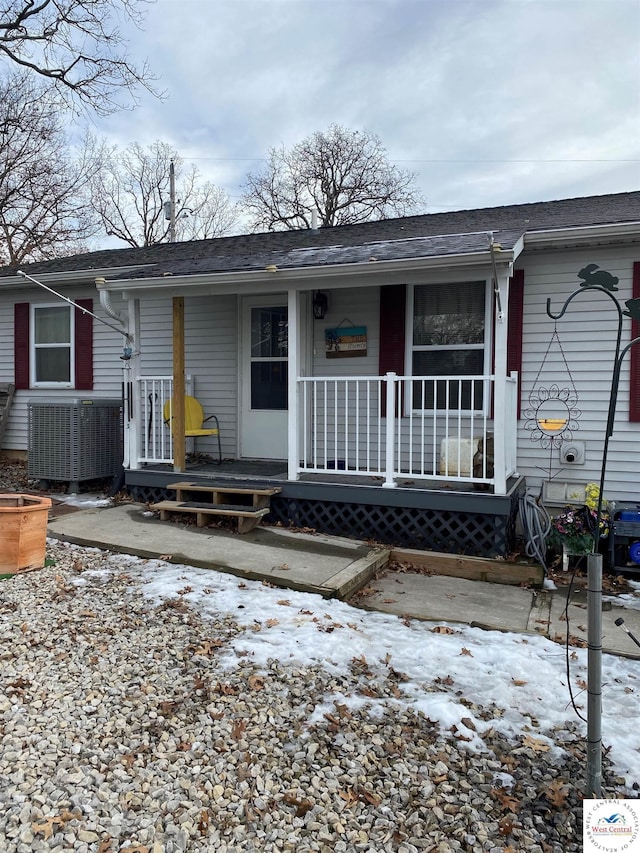 view of front of home with covered porch and central AC unit