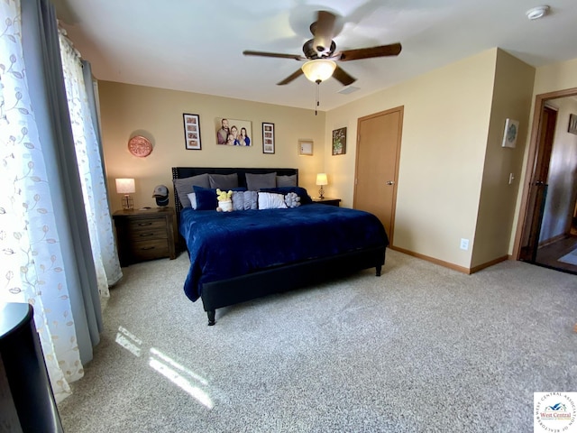 bedroom with light carpet, ceiling fan, and baseboards