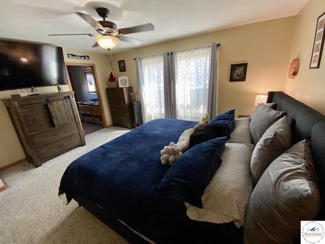 bedroom with a ceiling fan and light colored carpet