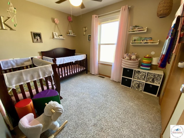 bedroom with a nursery area and carpet