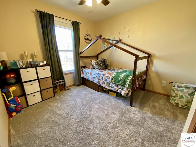 carpeted bedroom with ceiling fan and baseboards